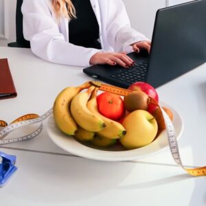 a woman sitting at a desk using a laptop computer