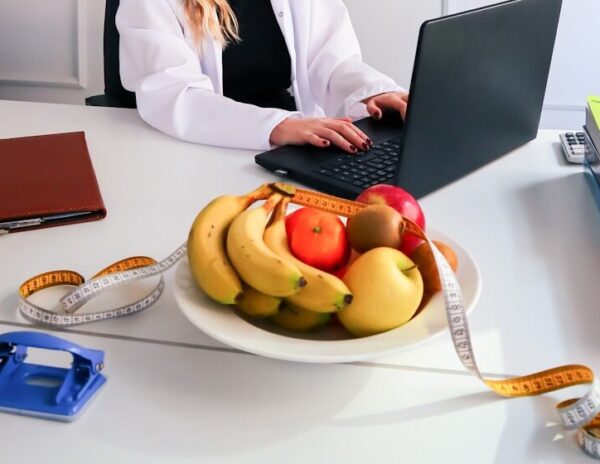 a woman sitting at a desk using a laptop computer